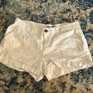 white old navy shorts with light printed gold pineapples on them